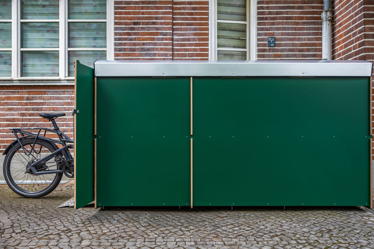 Grüne farabo Doppelbox vor Backsteinfassade mit E-Bike